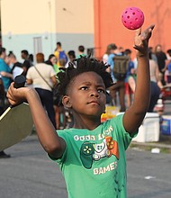 Kayden Cooper, 8, focuses on serving as he tries his hand at Pickleball for the first time during the Robinson Theater’s Annual Block Party on June 9 in Richmond’s Church Hill neighborhood. This was the first time that the popular Pickleball made its debut at the party that was attended by hundreds of people.