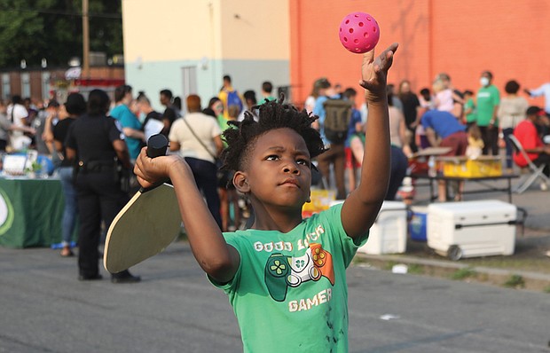 Kayden Cooper, 8, focuses on serving as he tries his hand at Pickleball for the first time during the Robinson Theater’s Annual Block Party on June 9 in Richmond’s Church Hill neighborhood. This was the first time that the popular Pickleball made its debut at the party that was attended by hundreds of people.