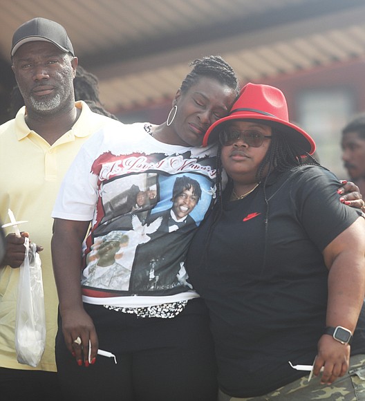 During a June 11 vigil at Abner Clay Park, Rennada Smith Bass, center, of Monroe La. is consoled as she and her family grieve the loss of their brother, Renzo Dell Smith, who was killed Tuesday, June 6 along with his stepson Shawn Jackson, 18. Before being shot, Mr. Jackson had just walked across the stage and received his diploma during his Huguenot High School graduation at Altria Theater. Richmond police note that none of the guns confiscated in the aftermath were brought into the Altria Theater. Police also said that the shooting sprang from a confrontation between Mr. Jackson and the shooter, Amari Pollard.