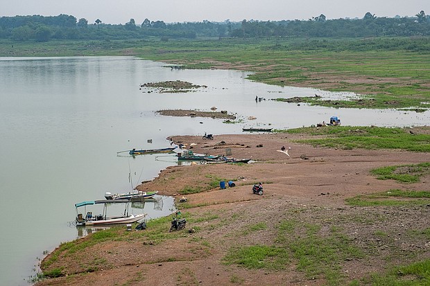 People fish along exposed banks, due to low water levels on Tri An Lake in Vinh Cuu, Dong Nai Province, Vietnam, on May 30. Major hydropower reservoirs in Vietnam are facing severe water shortages for the rest of the dry season due to El Niño, heat waves and drought.
Mandatory Credit:	Linh Pham/Bloomberg/Getty Images