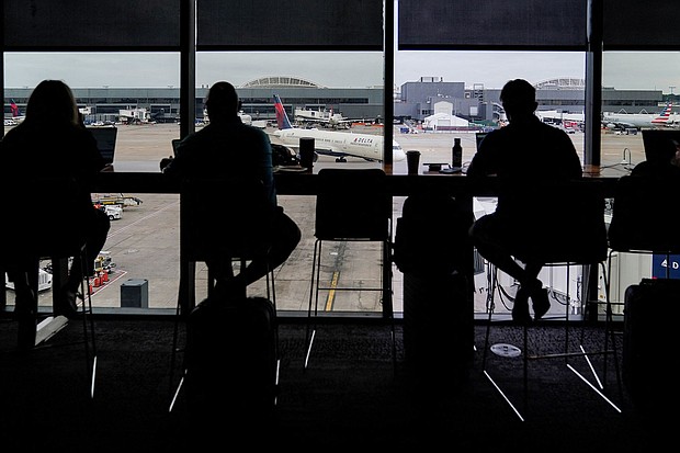 Passengers are seen in silhouette at a Delta Sky Club as an airplane parks at a gate in front of them at Hartsfield-Jackson Atlanta International Airport ahead of the Fourth of July holiday in Atlanta, Georgia, U.S., July 1, 2022.
Mandatory Credit:	Elijah Nouvelage/Reuters/FILE