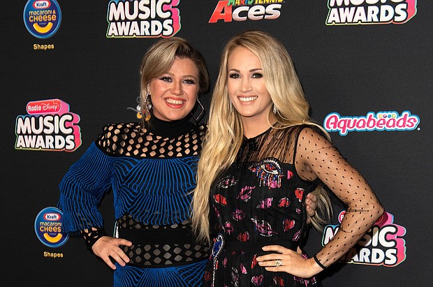 Kelly Clarkson (L) and Carrie Underwood attend the 2018 Radio Disney Music Awards at Loews Hollywood Hotel on June 12, 2018 in Hollywood, California.
Mandatory Credit:	Valerie Macon/AFP/Getty Images
