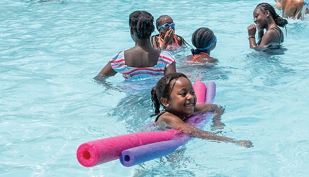 Heaven Saunders, 6, floats in Battery Park’s swimming pool with her cousins, from left, Johmyra Harris, 11, twin sisters Ja’lia Pringle-Saunders and Tai’lia Pringle-Saunders, both 10, and Jerrya Harris, 13. The girls were visiting the pool with their grandmother, Janice Pringle.