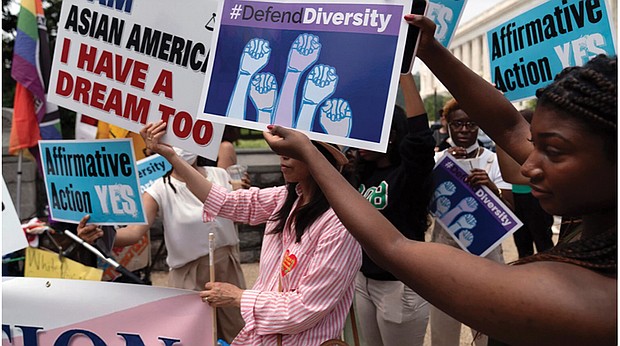 People protest outside the Supreme Court in Washington on June 29. Days after the Supreme Court outlawed affirmative action in college admissions, activists say they will sue Harvard over its use of legacy preferences for children of alumni.
