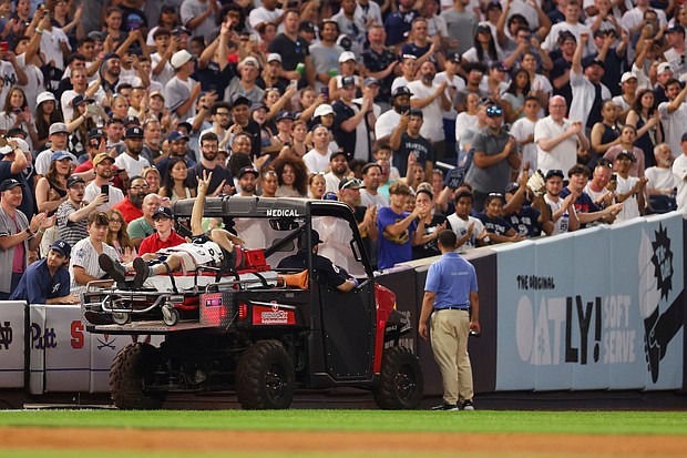 Pete Stendel waves to the crowd as he is carted off the field after getting hit by an errant throw in the fifth inning during the game between the New York Yankees and the Baltimore Orioles.
Mandatory Credit:	Mike Stobe/Getty Images