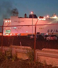 Smoke rises early Thursday from a cargo ship in the port of Newark, New Jersey.
Mandatory Credit:	WABC-TV/AP