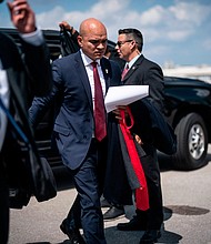 Walt Nauta, aide to former President Donald Trump, follows Trump as they board his airplane at Palm Beach International Airport on Monday, March 13.
Mandatory Credit:	Jabin Botsford/The Washington Post/Getty Images