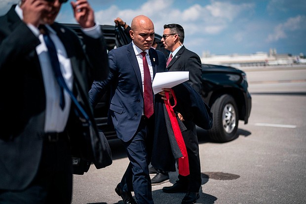Walt Nauta, aide to former President Donald Trump, follows Trump as they board his airplane at Palm Beach International Airport on Monday, March 13.
Mandatory Credit:	Jabin Botsford/The Washington Post/Getty Images