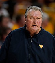 Bob Huggins watches from the bench during the first half of an NCAA college basketball game against Iowa State on February 27, in Ames, Iowa. Huggins now claims he did not resign from the school after he was arrested and charged with driving under the influence in Pittsburgh last month, his attorney said.
Mandatory Credit:	Charlie Neibergall/AP