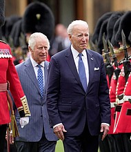 U.S. President Joe Biden and Britain's King Charles review an honorary guard at Windsor Castle in Windsor, England, Monday, July 10, 2023.
Mandatory Credit:	Kin Cheung/Reuters