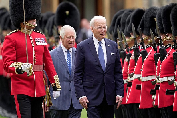 U.S. President Joe Biden and Britain's King Charles review an honorary guard at Windsor Castle in Windsor, England, Monday, July 10, 2023.
Mandatory Credit:	Kin Cheung/Reuters
