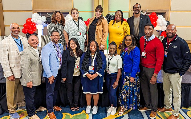 Superintendent James Colbert Jr., left, and Trustee Danny Norris, top right, pose for a photograph with members of the Harris County Department of Education staff that attended and presented at the HAABSE summer conference.