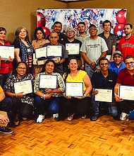 MAREK Construction employees who completed HCDE’s Adult Education ESL classes pose for a photograph after receiving their certificate of completion, Google Chromebooks, and T-Mobile hotspots.
