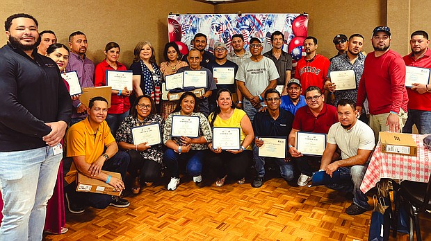 MAREK Construction employees who completed HCDE’s Adult Education ESL classes pose for a photograph after receiving their certificate of completion, Google Chromebooks, and T-Mobile hotspots.