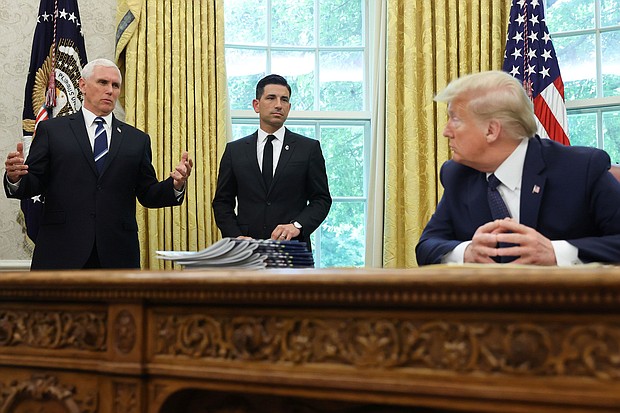 Then-US President Donald Trump listens to Vice President Mike Pence and acting Secretary of Homeland Security Chad Wolf, May 28, 2020.
Mandatory Credit:	Jonathan Ernst/Reuters