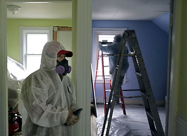 Contractors clean up lead paint at a contaminated building in Providence, Rhode Island. More than 30 million homes built before 1987 are estimated to have lead-based paint, the EPA says.
Mandatory Credit:	Chitose Suzuki/AP/File