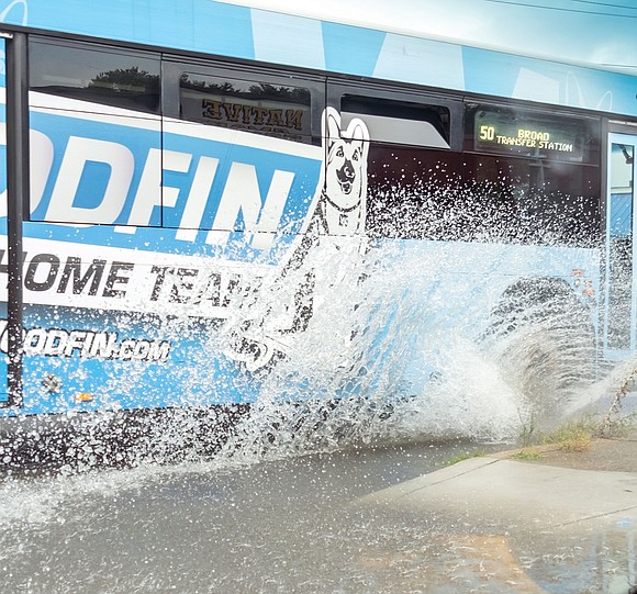 A GRTC bus makes a splash at the intersections of Broad Street and CommonwealthAvenue after a torrential downpour in Richmond …