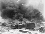 In this 1921 image provided by the Library of Congress, smoke billows over Tulsa, Okla. An Oklahoma judge has thrown out a lawsuit seeking reparations for the 1921 Tulsa Race Massacre, dashing an effort to obtain some measure of legal justice by survivors of the deadly racist rampage.