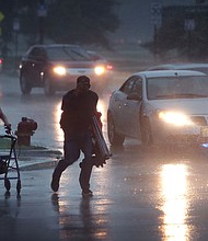 People search for cover as a derecho storm pushes through Chicago, Illinois, in August 2020. A derecho is a significant, potentially destructive weather event that is characterized as having widespread, long-lived, straight-line winds.
Mandatory Credit:	Scott Olson/Getty Images/File