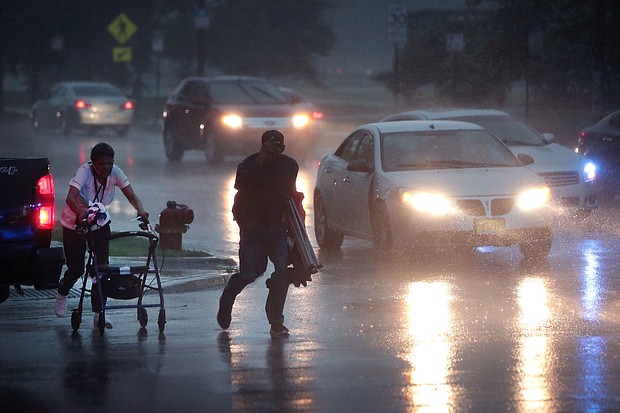 People search for cover as a derecho storm pushes through Chicago, Illinois, in August 2020. A derecho is a significant, potentially destructive weather event that is characterized as having widespread, long-lived, straight-line winds.
Mandatory Credit:	Scott Olson/Getty Images/File