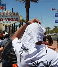 A man shields himself from the sun while waiting to take a photo in Las Vegas on July 14.
Mandatory Credit:	Ronda Churchill/AFP/Getty Images