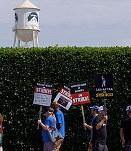 SAG-AFTRA actors and Writers Guild of America (WGA) writers walk the picket line in front of Paramount Studios in Los Angeles, on July 17.
Mandatory Credit:	Mike Blake/Reuters