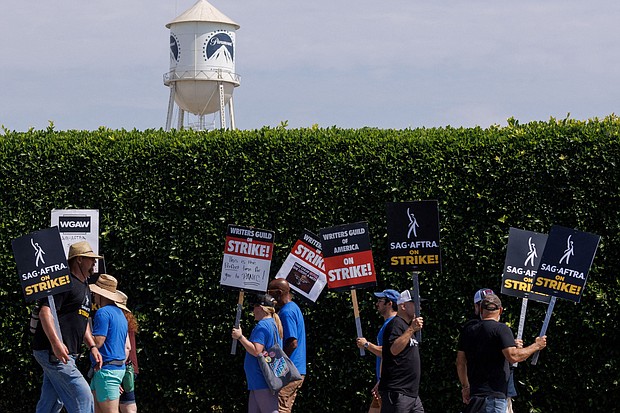SAG-AFTRA actors and Writers Guild of America (WGA) writers walk the picket line in front of Paramount Studios in Los Angeles, on July 17.
Mandatory Credit:	Mike Blake/Reuters