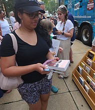 Whitney Smith of Richmond, one of the 60 people who attended the rally, chose a copy of Alice Walker’s “The Color Purple” as the banned book she planned to read. We The People for Education, which backs Virginia candidates who are pro-public schools, hosted the bookmobile’s visit.