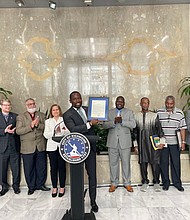 Mayor Levar M. Stoney, shown Monday at City Hall, shows his proclamation declaring July as Muslim American Heritage Month in Richmond while members of the area’s Islamic community applaud what representatives described as a “tremendous honor.” Richmond is the first city in the state and one of the few in the nation to proclaim the month in recognition of Muslims and their contributions. Among those who joined the mayor is Richmond state Sen. Ghazala Hashmi, immediate left of Mayor Stoney. Sen. Hashmi is the first Muslim member of the Virginia General Assembly’s upper chamber.