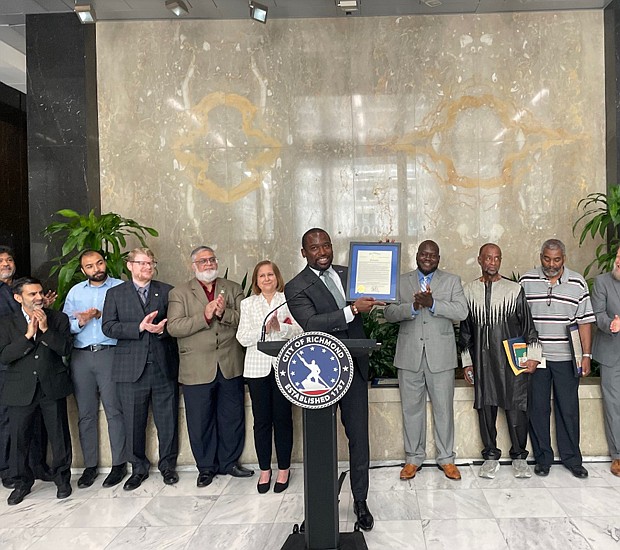 Mayor Levar M. Stoney, shown Monday at City Hall, shows his proclamation declaring July as Muslim American Heritage Month in Richmond while members of the area’s Islamic community applaud what representatives described as a “tremendous honor.” Richmond is the first city in the state and one of the few in the nation to proclaim the month in recognition of Muslims and their contributions. Among those who joined the mayor is Richmond state Sen. Ghazala Hashmi, immediate left of Mayor Stoney. Sen. Hashmi is the first Muslim member of the Virginia General Assembly’s upper chamber.