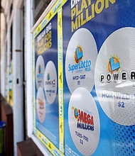 A California Lottery poster advertises Powerball and other lotteries at a convenience store on July 18, in Los Angeles.
Mandatory Credit:	Mario Tama/Getty Images
