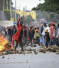 Protesters stand by a burning barricade on a street in the Mathare neighborhood of Nairobi, Kenya, on July 12.
Mandatory Credit:	AP