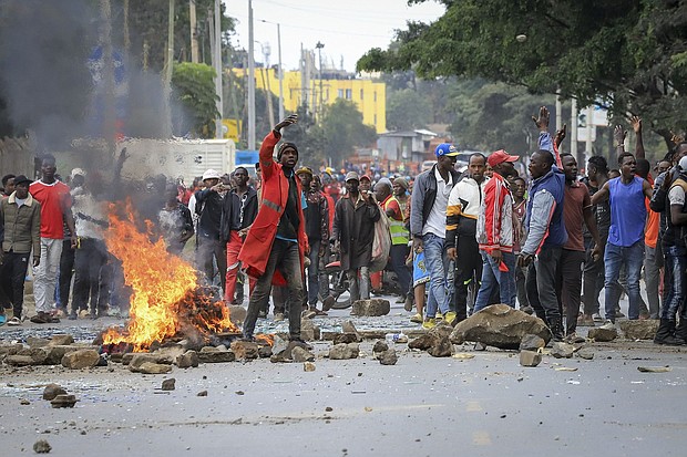 Protesters stand by a burning barricade on a street in the Mathare neighborhood of Nairobi, Kenya, on July 12.
Mandatory Credit:	AP