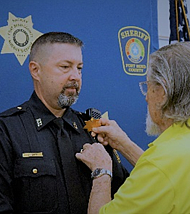 Lt. William Sparks being pinned by his father, Jimmy Sparks.