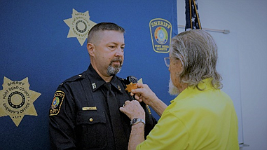 Lt. William Sparks being pinned by his father, Jimmy Sparks.