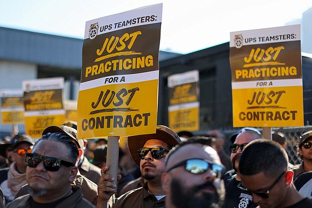 UPS and the Teamsters have reached a tentative deal on a new contract. UPS teamsters here hold a rally outside a UPS facility in Los Angeles, on July 19.
Mandatory Credit:	Mike Blake/Reuters
