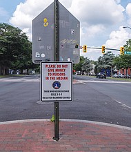 New signs at Belvidere and Marshall streets are among several throughout the city that ask drivers to stop giving money to panhandlers.