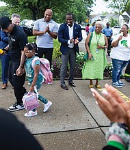 Richmond Public School officials, teachers and staff greet parents and students on the first day of a new pilot program at Fairfield and Cardinal elementary schools.