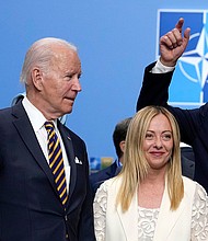 President Joe Biden and Italy's Prime Minister Giorgia Meloni wait to have their photo taken during a NATO summit in Vilnius, Lithuania, July 12.
Mandatory Credit:	Pavel Golovkin/AP