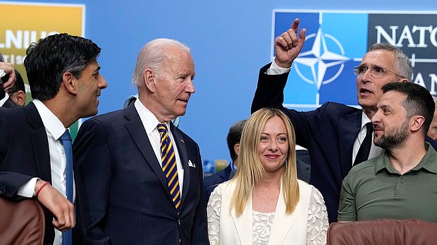 President Joe Biden and Italy's Prime Minister Giorgia Meloni wait to have their photo taken during a NATO summit in Vilnius, Lithuania, July 12.
Mandatory Credit:	Pavel Golovkin/AP