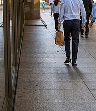 Pictured are pedestrians on California Street in the financial district of San Francisco, in 2022.
Mandatory Credit:	David Paul Morris/Bloomberg/Getty Images