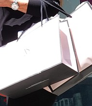 The pace of price increases slowed last month. A pedestrian carries shopping bags while walking through Union Square in San Francisco.
Mandatory Credit:	Justin Sullivan/Getty Images/FILE