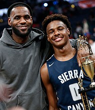 LeBron James, left, poses with his son Bronny after Sierra Canyon beat Akron St. Vincent - St. Mary in a high school basketball game, December 14, 2019, in Columbus, Ohio.
Mandatory Credit:	Jay LaPrete/AP