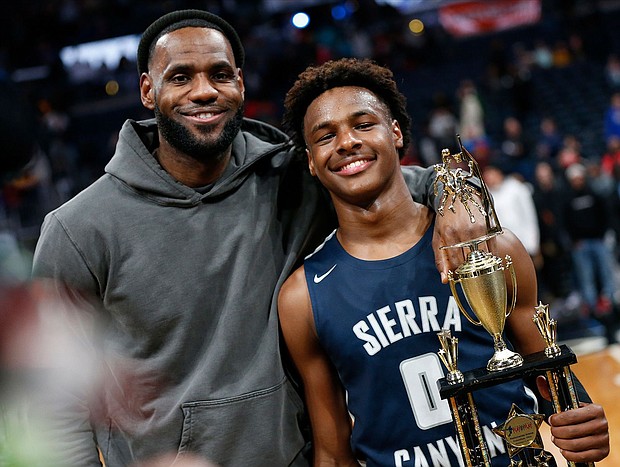 LeBron James, left, poses with his son Bronny after Sierra Canyon beat Akron St. Vincent - St. Mary in a high school basketball game, December 14, 2019, in Columbus, Ohio.
Mandatory Credit:	Jay LaPrete/AP