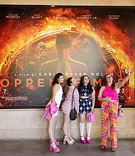 From left, Gabrielle Roitman, Kayla Seffing, Maddy Hiller and Casey Myer take a selfie in front of an "Oppenheimer" movie poster before they attended an advance screening of "Barbie," on July 20 at AMC The Grove 14 theaters in Los Angeles.
Mandatory Credit:	Chris Pizzello/AP