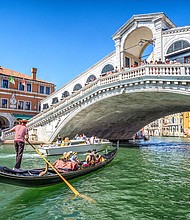 A gondola packed with tourists goes under the Rialto Bridge on the Grand Canal in Venice.
Mandatory Credit:	Eloi_Omella/iStock Unreleased/Getty Images