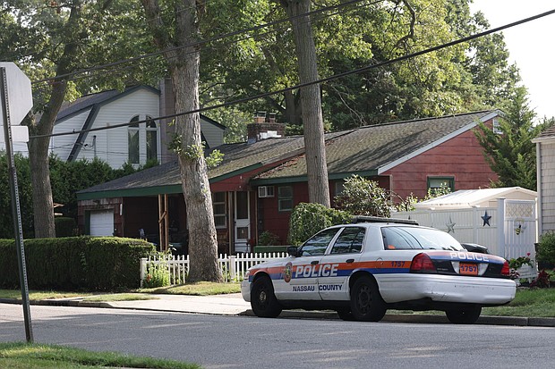 Nassau County police car is parked outside the home of alleged killer of three sex workers in the Gilgo Beach case, Rex Heuermann, on July 26.
Mandatory Credit:	James Carbone/Newsday RM/Getty Images