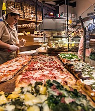 Different varieties of pizza served al taglio in a bakery of Rome's Trastevere neighborhood.
Mandatory Credit:	Stefano Politi Markovina/Alamy Stock Photo