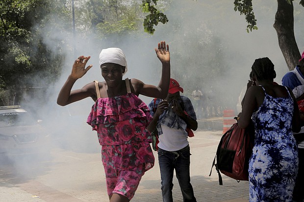 Haitians flee tear gas fired by officers clearing a camp of people at the US embassy seeking to escape the violence of armed gangs on July 25.
Mandatory Credit:	Ralph Tedy Erol/Reuters