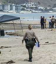 Members of the Los Angeles County Sheriff's Department investigate at  Malibu Lagoon State Beach, where a body was found inside a 55-gallon drum.
Mandatory Credit:	Mel Melcon/Los Angeles Times/Getty Images
